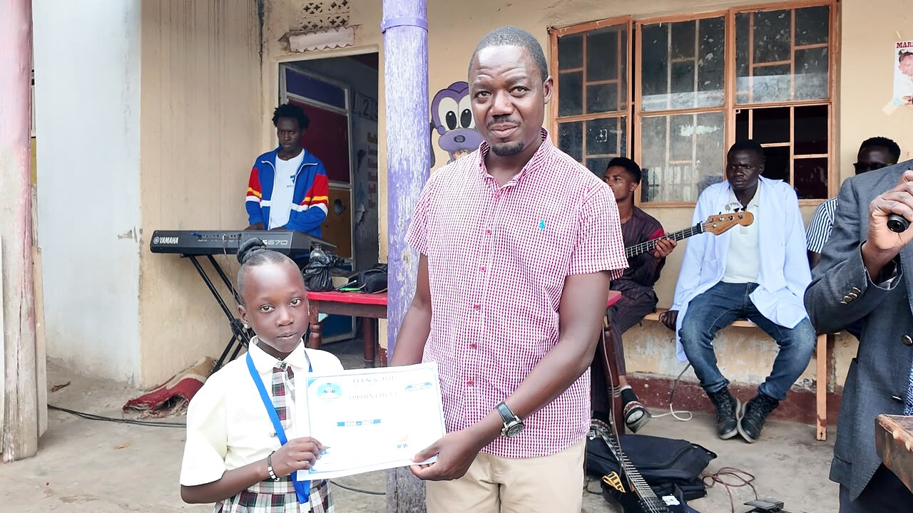 A learner receives a certificate during a school ceremony.