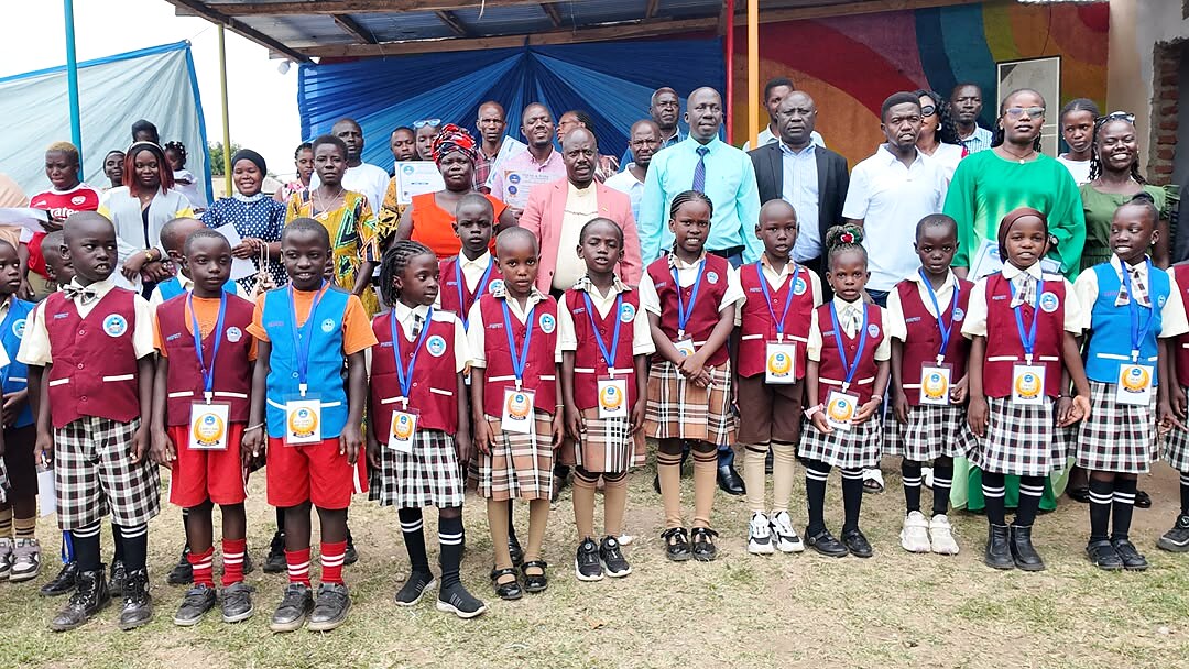 Learners and adults pose together at a school event.